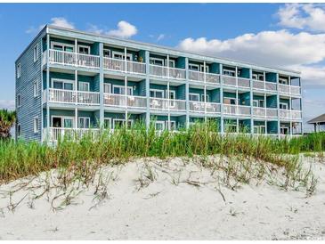Multi-story building directly on the beach with multiple balconies at 116 South Waccamaw Dr. # 204, Garden City Beach, SC 29576