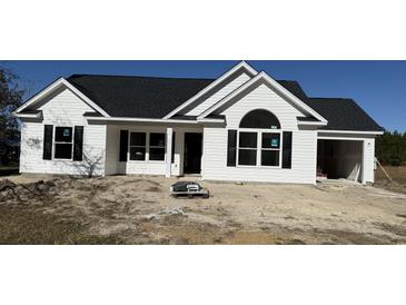 New construction home with white siding, black shutters, and a dark roof at 4512 Old Tram Rd., Conway, SC 29527