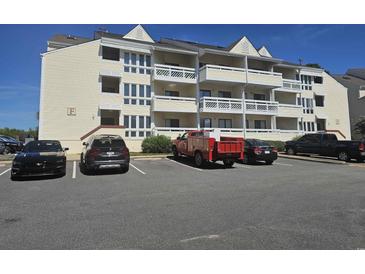 Exterior view of a multi-unit building with parking at 1100 Possum Trot Rd. # F-224, North Myrtle Beach, SC 29582