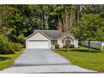 Charming single-story house with a paved driveway and well-maintained lawn at 251 Galapagos Dr., Little River, SC 29566