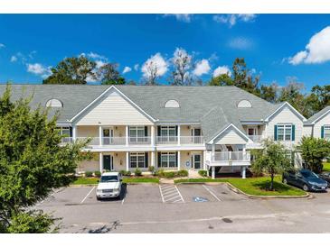 Two-story condo building with a welcoming facade and ample parking at 146 Scotch Broom Dr. # P-204, Little River, SC 29566