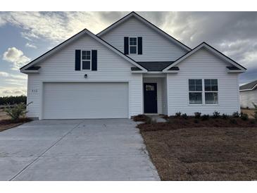 Charming two-story home with white siding, attached two-car garage, and landscaped yard at 832 Buttonwood Dr., Conway, SC 29527