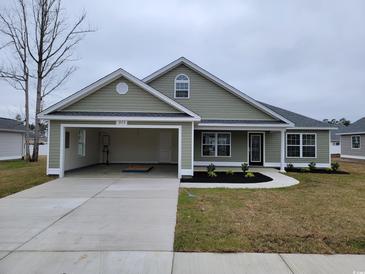 One-story house with attached garage, landscaping, and neutral exterior at 6220 Ellwood Rd., Galivants Ferry, SC 29544