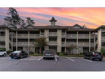 Exterior view of a condo building with parking and landscaping at 1551 Spinnaker Dr. # 5822, North Myrtle Beach, SC 29582