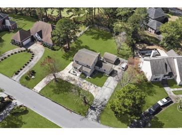 Aerial view of a charming house with a large backyard and driveway at 3763 Annandale Dr., Myrtle Beach, SC 29577