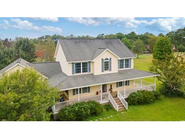 Two-story house with large wrap-around porch and spacious backyard at 9396 S Highway 905, Longs, SC 29568