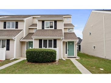 Two-story townhouse with teal door and landscaping at 500 Deer Creek Rd. # D, Surfside Beach, SC 29575