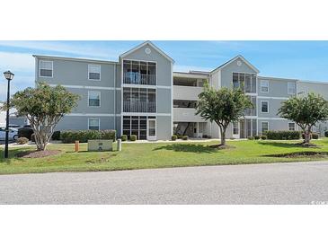 Gray two-story building with screened porches and landscaping at 1960 C Bent Grass Dr. # C, Surfside Beach, SC 29575