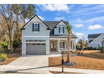 Charming two-story home with gray siding and a welcoming front porch at 204 Bouquets Green Way, Myrtle Beach, SC 29579