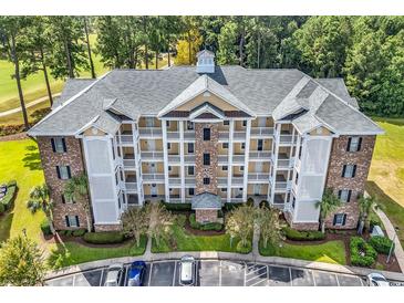 Exterior view of multi-story building and parking at 4870 Luster Leaf Circle # 401, Myrtle Beach, SC 29577