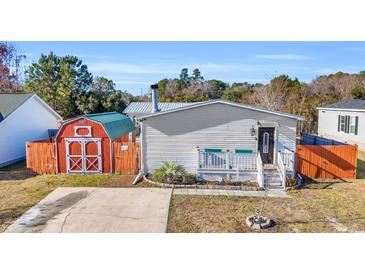Single-wide mobile home with detached shed and fenced yard at 8586 Edgewood Dr., Myrtle Beach, SC 29588