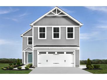 Two-story gray house with white garage doors and landscaping at 1092 Oak Meadow Dr., Conway, SC 29526