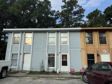 Two-unit building with gray and wood siding at 3456 Macklen Rd. # 18-B, Myrtle Beach, SC 29588