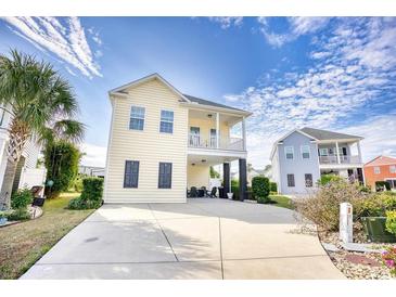 Two-story home with a wrap-around porch and attractive landscaping at 911 Ocean Pines Ct., North Myrtle Beach, SC 29582