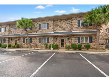 Brick building with parking lot and palm trees at 215 Double Eagle Dr. # G-2, Myrtle Beach, SC 29575