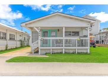 Quaint beach cottage with a welcoming front porch at 6001-1424 S Kings Hwy., Myrtle Beach, SC 29575