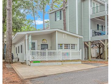Small cottage with a deck and white railing at 6001-1359 S Kings Hwy., Myrtle Beach, SC 29575