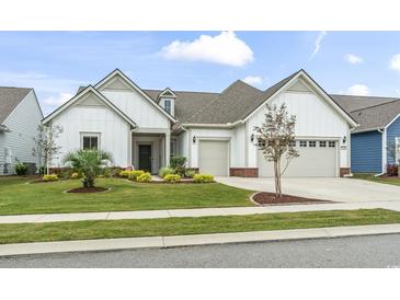 Charming two-story home with a two-car garage and well-manicured lawn at 7129 Spoleto Dr., Myrtle Beach, SC 29572