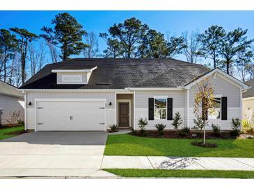 One-story house with gray siding, white trim, and a two-car garage at 623 Blackthorne Circle Nw, Calabash, NC 28467