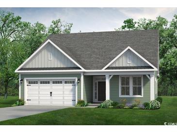 Quaint craftsman style home with a two car garage and welcoming porch at 876 Mountain Mint Circle Nw, Calabash, NC 28467