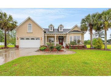 Beautiful house exterior with well-maintained landscaping and a two car garage at 3712 Faith Dr., Conway, SC 29527