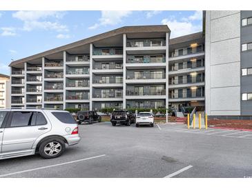 Building exterior showcasing ample parking and oceanfront location at 5905 S Kings Highway # 210B, Myrtle Beach, SC 29575