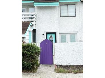 Exterior view of a townhome with purple gate and teal door at 306 21St Ave. S # 4A, Myrtle Beach, SC 29577