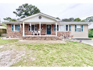 Charming ranch-style home with brick facade and covered porch at 703 62Nd Ave. N, Myrtle Beach, SC 29572
