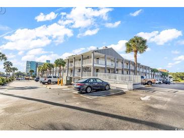 Exterior view of a two-story building with parking at 6803 N Ocean Blvd. # 230, Myrtle Beach, SC 29572