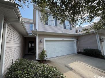 Two story light beige townhome with a two-car garage at 1188 Fairway Ln. # 7, Conway, SC 29526