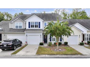 Two-story townhouse with gray siding and a two-car garage at 160 Freeboard Ln. # 802, Carolina Shores, NC 28467