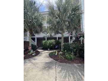 Attractive building exterior with landscaping and walkway at 1538 Lanterns Rest Rd. # 303, Myrtle Beach, SC 29579