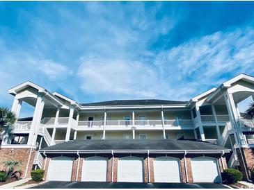 Three-story building with multiple garages and balconies at 4819 Orchid Way # 104, Myrtle Beach, SC 29577