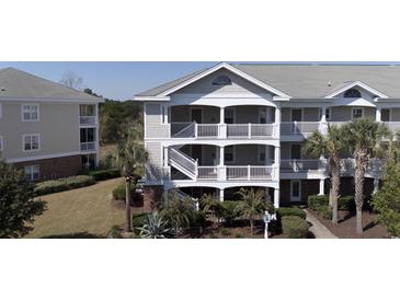 Two-story townhouse with gray siding and balconies at 5801 Oyster Catcher Dr. # 1531, North Myrtle Beach, SC 29582