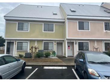 Two-story townhome with light green and pink exterior at 1210 Pinegrove Dr. # G, Myrtle Beach, SC 29577