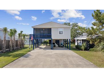 Elevated beach house with a screened porch and parking at 405 N 30Th Ave. N, North Myrtle Beach, SC 29582