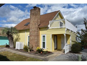 Yellow house with a second story deck at 704 43Rd Ave. S, North Myrtle Beach, SC 29582
