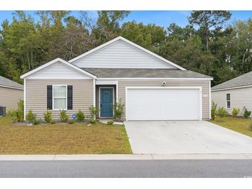 One-story house with a two-car garage and well-maintained lawn at 338 Spruce Pine Way, Conway, SC 29526