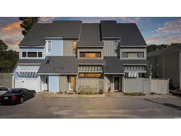 Two-story townhome with light blue and gray siding at 7300 Porcher Dr. # 8, Myrtle Beach, SC 29572