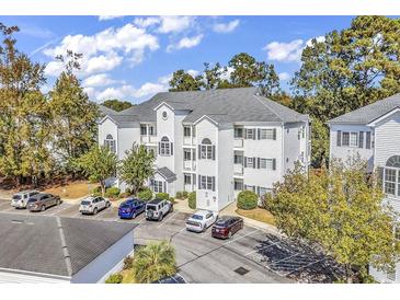 Aerial view of a three-story building with parking at 1525 Lantern Rest Dr. # 301, Myrtle Beach, SC 29579