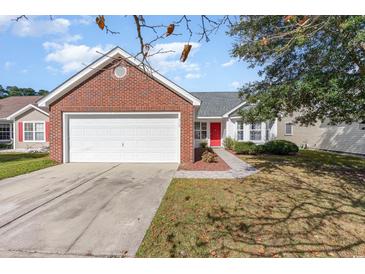 Brick ranch home with attached garage and red door at 419 Mckendree Ln., Myrtle Beach, SC 29579