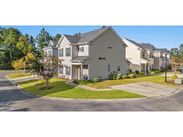 Two-story townhome with light beige siding and landscaping at 154 Terracina Circle, Myrtle Beach, SC 29588