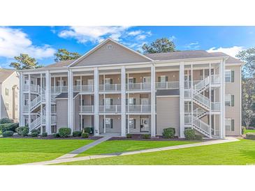 Two-story building with multiple units and ample parking at 5804 Longwood Dr. # 203, Murrells Inlet, SC 29576