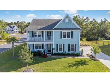 Two-story light-blue house with a white garage and well-maintained lawn at 1315 Bermuda Grass Dr., Myrtle Beach, SC 29579