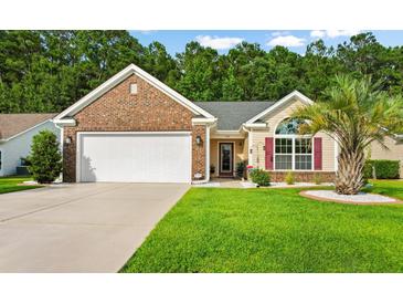 Brick house with two-car garage and lush lawn at 544 Running Deer Trail, Myrtle Beach, SC 29588