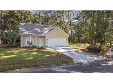 Single-story house with attached garage and landscaping at 4533 Greenbriar Dr., Little River, SC 29566