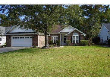 Brick ranch home with attached garage and well-maintained lawn at 9606 Indigo Creek Blvd., Murrells Inlet, SC 29576