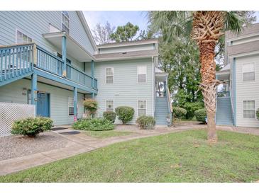Light blue two-story building with stairs and balconies at 4337 Spa Dr. # 1309, Little River, SC 29566