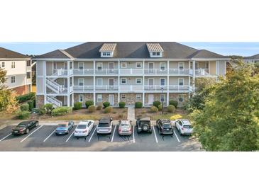 Three-story building exterior with parking and landscaping at 800 Crumpet Ct. # 1119, Myrtle Beach, SC 29579