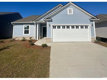 Newly built home with two-car garage and landscaping at 293 Hawks Run Dr., Calabash, NC 28467
